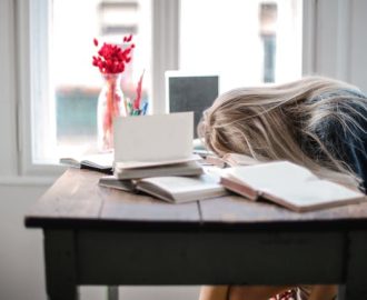 woman with head on her books