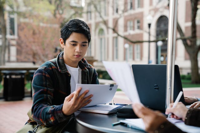 young man reading essay